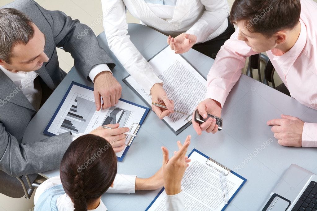 Business team discussing financial strategies and data analysis at a meeting.