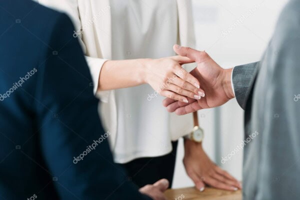 Handshake between two professionals for client support.