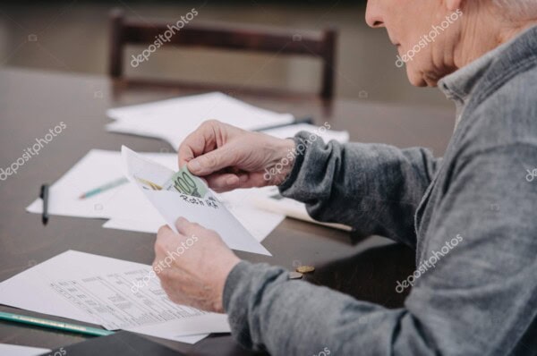 Financial planning with retirement documents and cash.