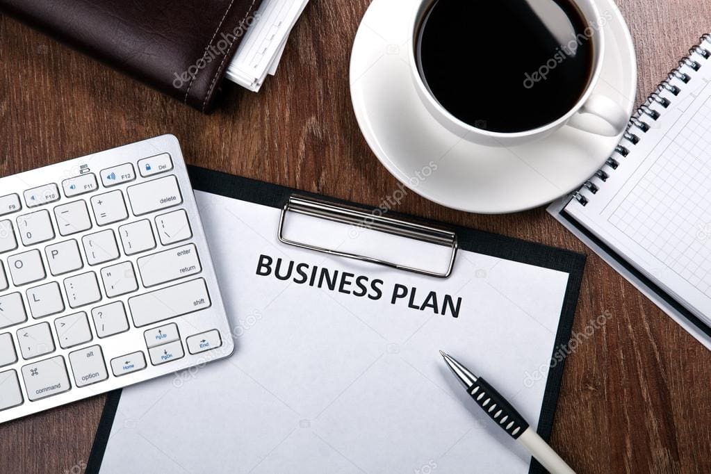 Retirement plan document on clipboard with coffee, keyboard, and notepad.